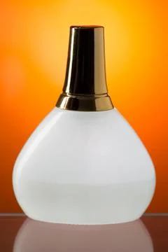 White bottle stands on the mirror surface Stock Photos