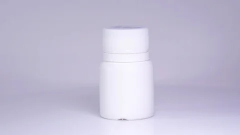 White bottle with tablets on a white background Stock Footage 129607128