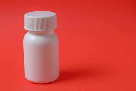 White bottles on red background Stock Photos