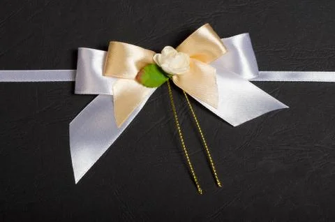 White bow with a flower. Stock Photos