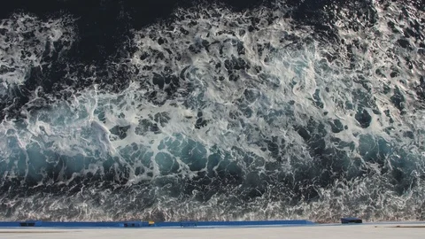 White bow waves go fast by the side board of a big ferryboat. Cruising the sea Stockbeeldmateriaal 99003783