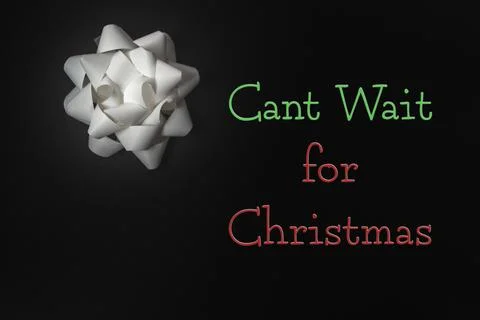 White bow with the words can't wait for christmas written in red and green Stock Photos