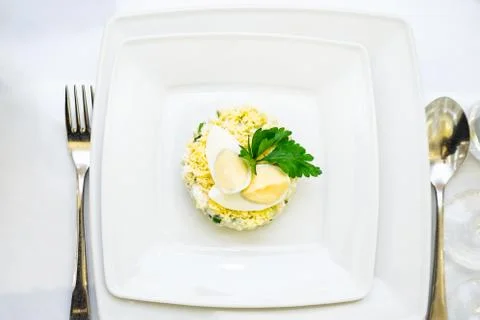 White bowl of deviled Egg Salad on table Stock Photos