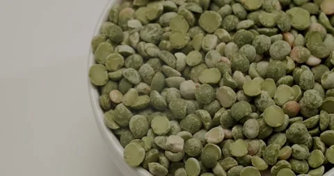 White bowl of dried green split peas rotating 動画素材 344321959