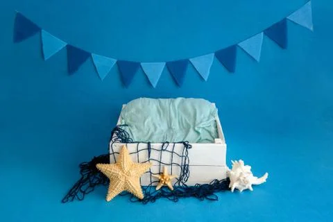 A white box on a blue background is decorated in nautical style. Close-up. Stock Photos