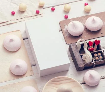 White box with different sweets on table 写真素材