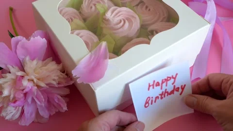 A white box filled with colored meringue cookies and happy birthday card, A.. Видео 295215311