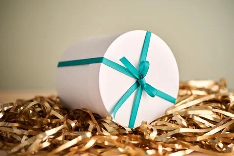 White box with a gift in tinsel. Stock Photos
