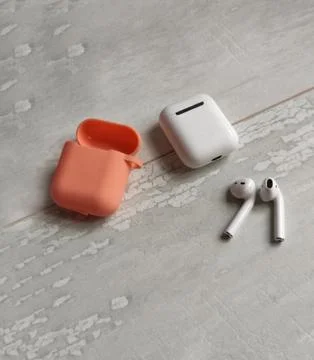 White box for storage and charging with silicone protective covering. Wireles Stock Photos