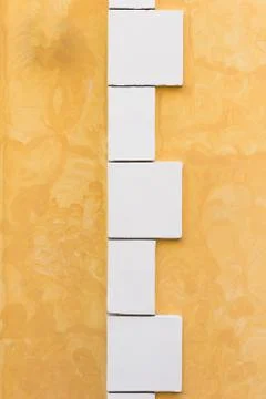 White boxes in the background of an orange wall Stock Photos