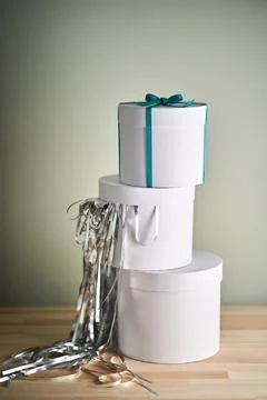 White boxes with a gift in tinsel. Stock Photos