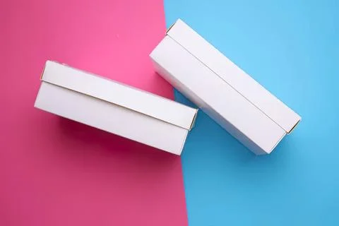 White boxes on pink and blue background for product packaging Stock Photos
