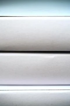 White boxes stacked in a row on a shelf Stockfoto's