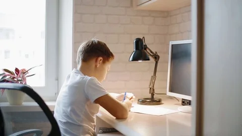 White boy doing his hometask Stock Footage 82861207