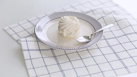 White braided marshmallow on a white and blue plate. Sugar food. Stock Footage 344834002