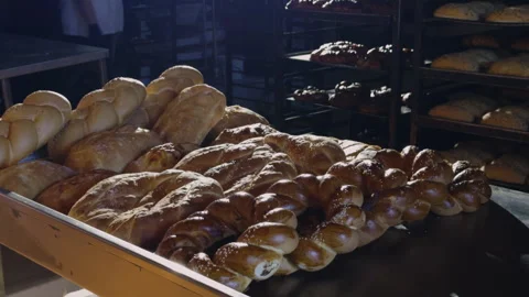 White bread baked on a bakery conveyor belt. Freshly baked bread and rolls, with Stock Footage 277618181