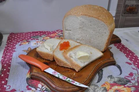 White bread on a board with red caviar Stock-Fotos