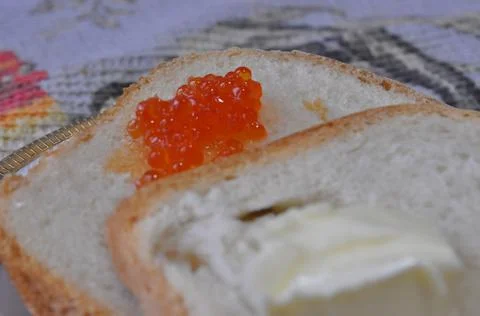 White bread on a board with red caviar Stock Photos