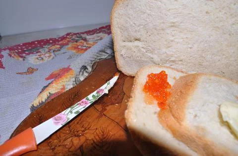 White bread on a board with red caviar Stock-Fotos