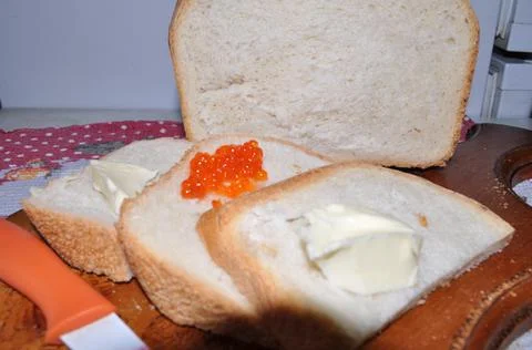 White bread on a board with red caviar Stock Photos