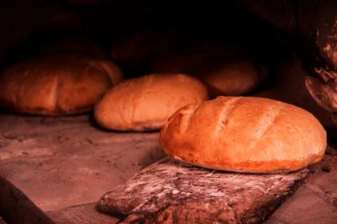 White bread is cooked in an old oven Stock Photos