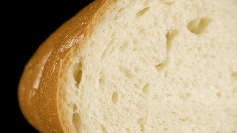 White bread on a dark background close-up slow motion Stock Footage 100154349