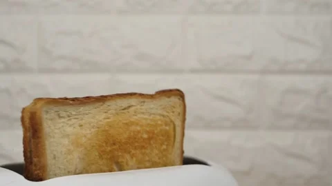 White bread flying out of an electric toaster on a white brick background Stock Footage 236148196