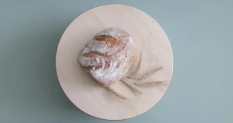 White bread loaf spinning on wooden board Stock Footage 201442798