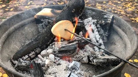 White bread roasted over an open fire. Video stock 97566805