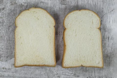 White bread slice isolated on wood background Stock Photos