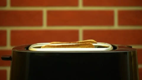 White bread slightly pops out of a toaster when ready Stock-Footage 221362589