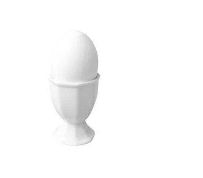 White breakfast egg in white egg cup isolated Stock Photos