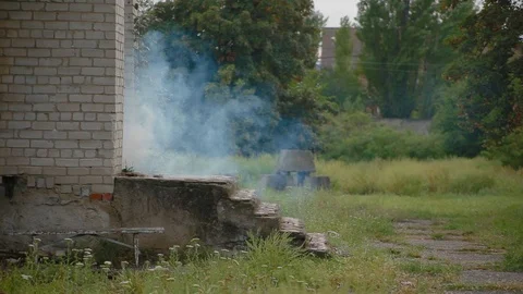 White brick house from which comes puff of smoke, danger of gas explosion Stock Footage 117994340