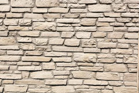 Off white brick stone wall, different size bricks, textured Stock Photos