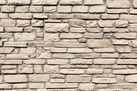 Off white brick stone wall, different size bricks, textured Stock Photos