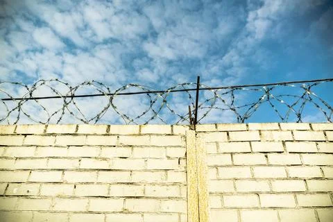 White Brick Wall and Barbed Wire Stock Photos