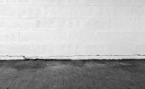 White brick wall background and black concrete floor. 스톡 사진
