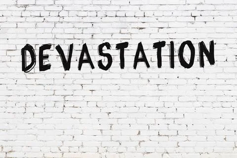  White brick wall with inscription devastation handwritten with black paint Stock Illustration