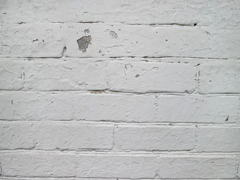 White brick wall painted with old paint. Solid light background with old ag.. 写真素材