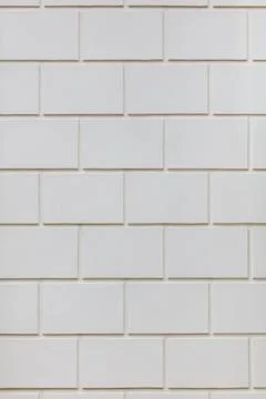 A white brick wall with a pattern of squares Stock Photos
