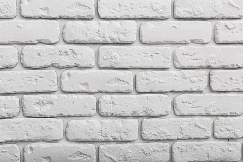 White brick wall with smooth and rugged textures ideal for interior design and Stock Photos