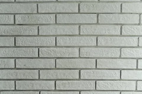 White brick wall with subtle texture creates clean abstract background. Wal.. Stock Photos