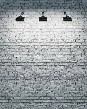 White brick wall with three spotlights Stock Photos