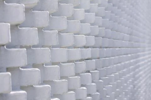 White brick wall in unusual pattern with bricks sticking out Stock Photos