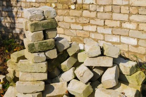 White bricks in a pile of building materials and waste on the background of a Stock Photos
