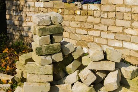 White bricks in a pile of building materials and waste on the background of a Stock Photos