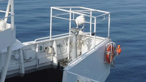 White bridge wing of a cargo ship with a orange lifebouy Stock Footage 117163892