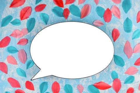 White bubble on the bright background coverd with colorful feathers. Stock Photos