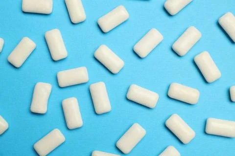 White bubble gums on blue background, flat lay Stock Photos