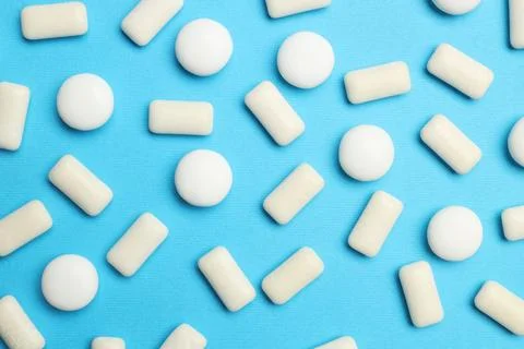 White bubble gums on blue background, flat lay Stock Photos